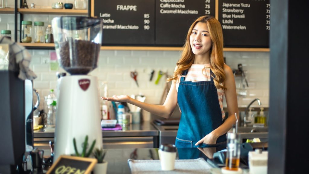 A coffee shop owner ready to serve her customers