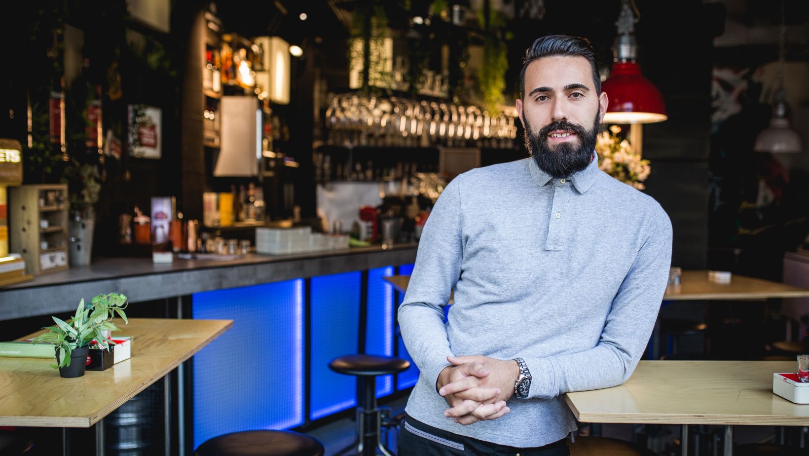 Bar owner poses inside his bar