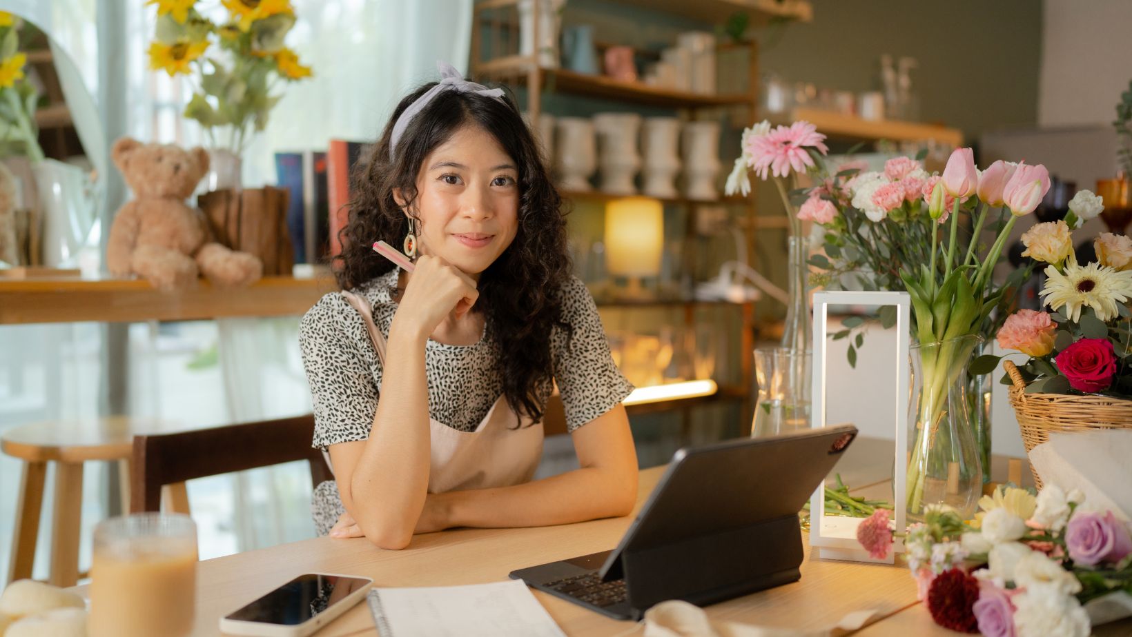 A florist strategizing behind a counter in a flower shop