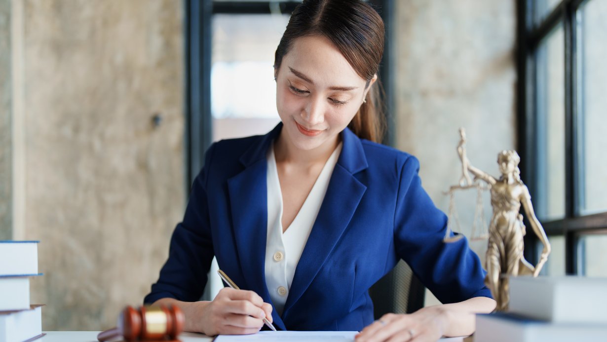 An attorney working on some paperwork, gavel on desk