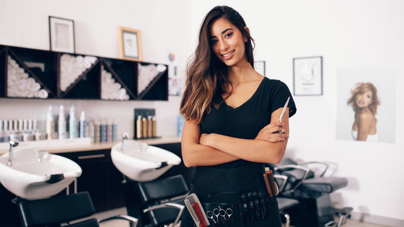 Image of a hairdresser posing inside her salon