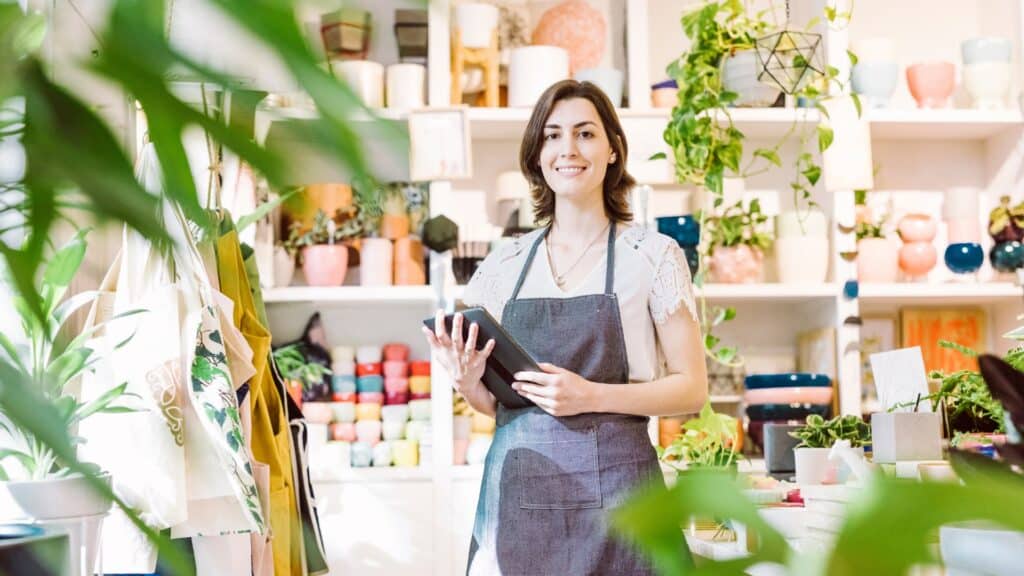 Small business owner smiling for the picture while doing her inventory.