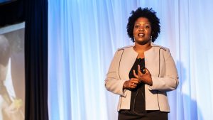 Kisha Zullo speaking on stage